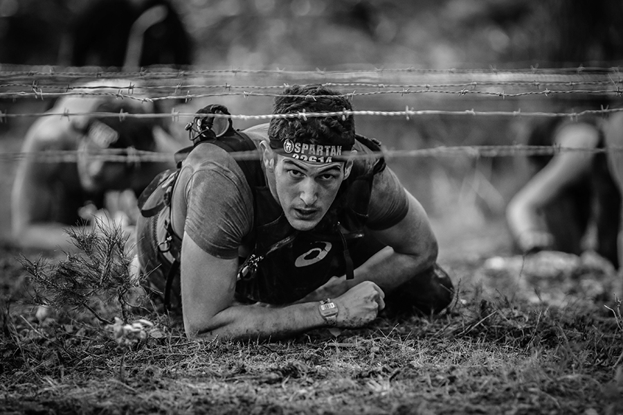 Spartan Race crawling under barb wire