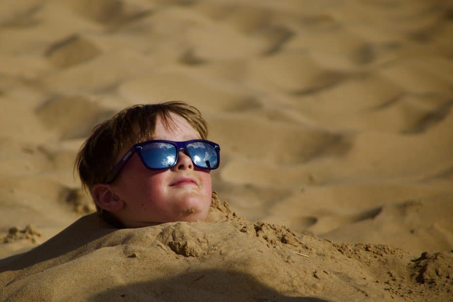 Front end developer buried in the sand up to his neck